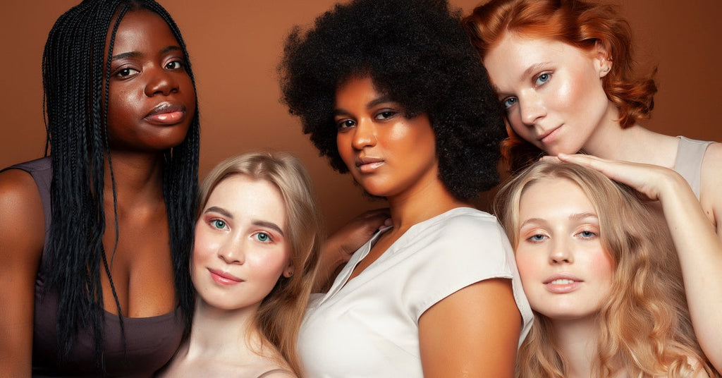 A diverse group of women modeling with a natural look. They're wearing light makeup with their natural hair.